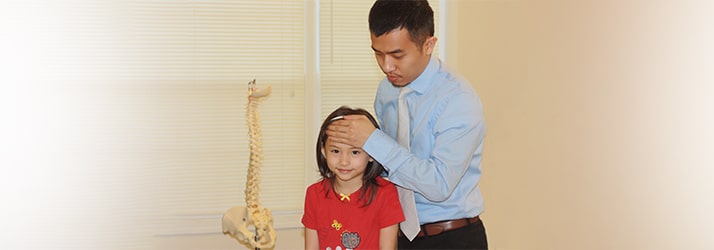 Chiropractor Lawrenceville GA Hung Vuong adjusting patient Chiropractor Lawrenceville GA Hung Vuong adjusting patient